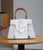 Elegant Crocodile-Embossed White Handbag with Wooden Handle & Modern Buckle Detail